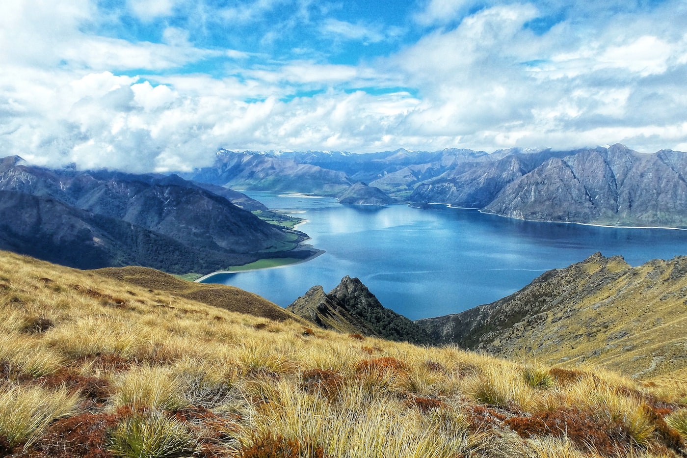 Bare hills reflected in a perfectly still South Island lake